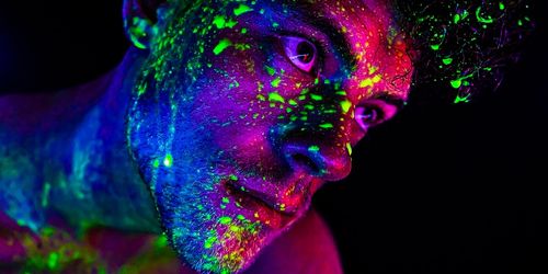 Man with neon paint on face