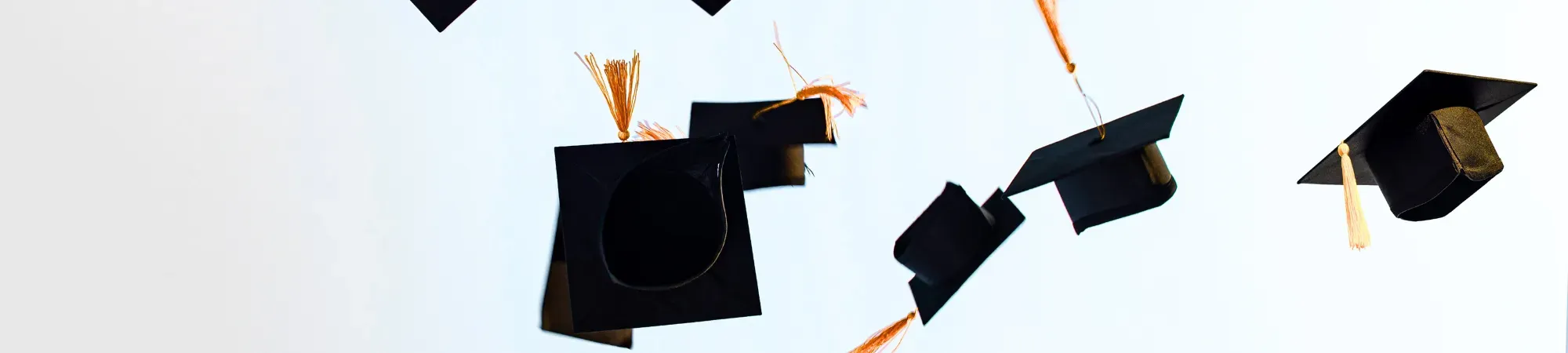 Graduation Hats flying in the air
