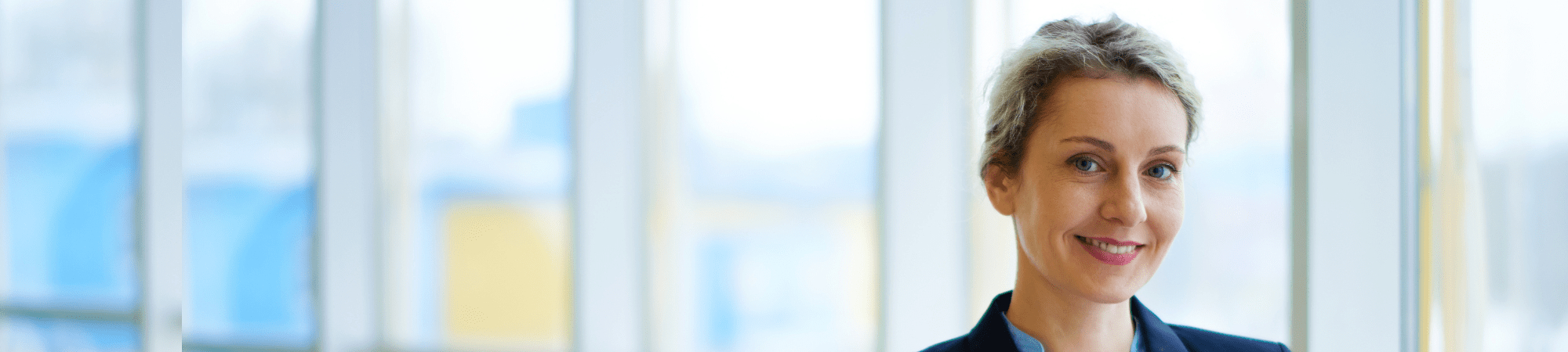 Smiling employee in a conference room setting.