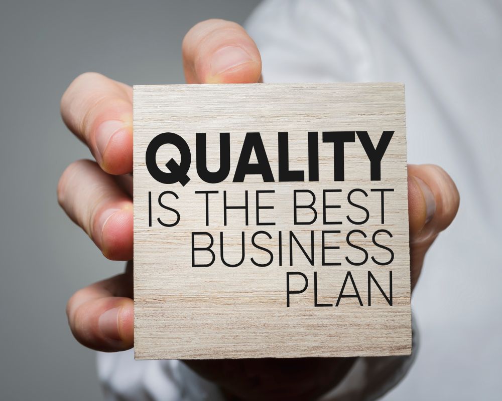 quality is the best business plan on a wooden block