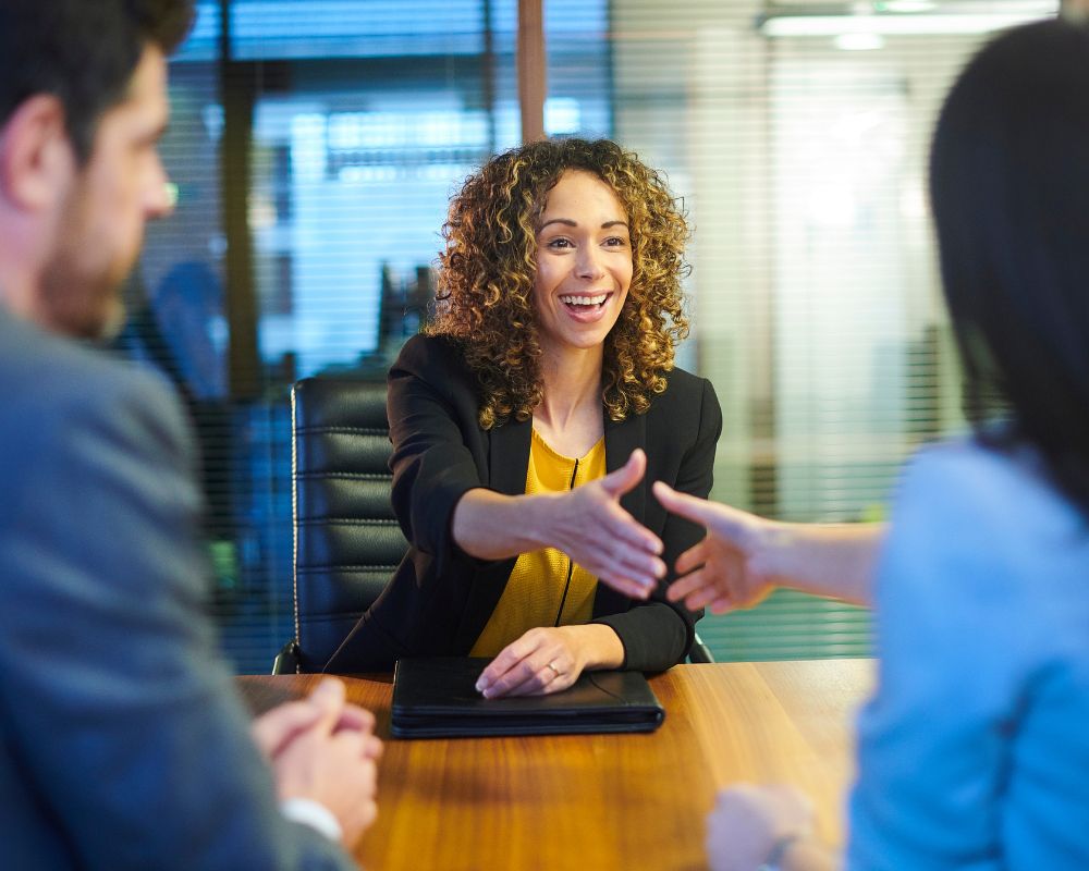 Woman shaking hands at second interview