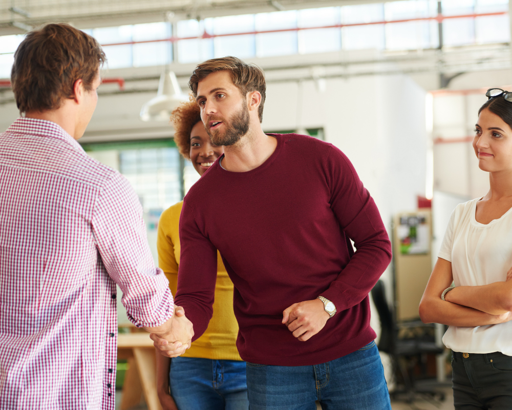 Man shaking hands in a group