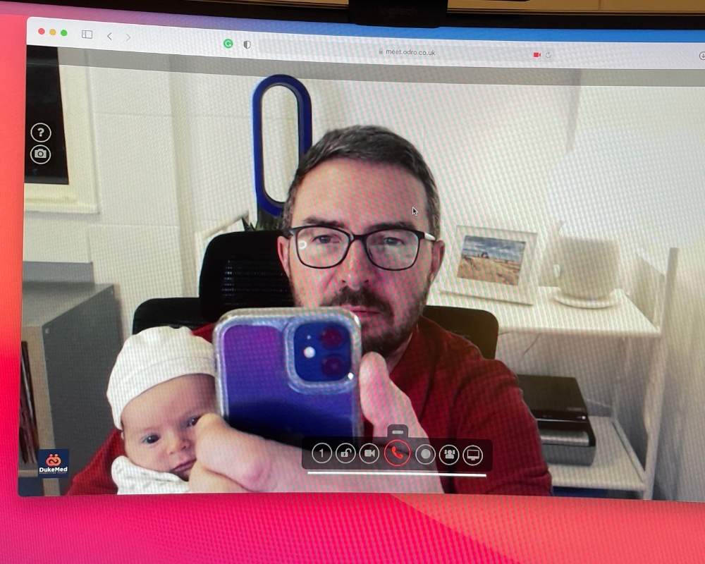 Man taking a selfie with a baby