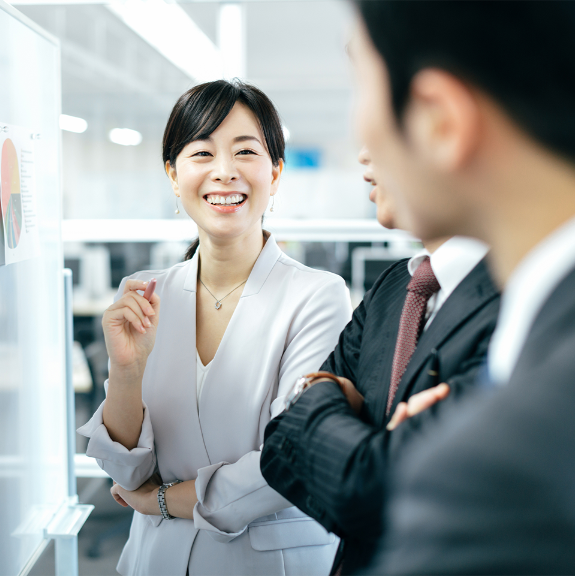 Japanese business woman smiling with her co workers