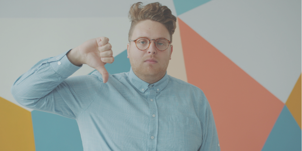 Disappointed man with his thumb pointing down