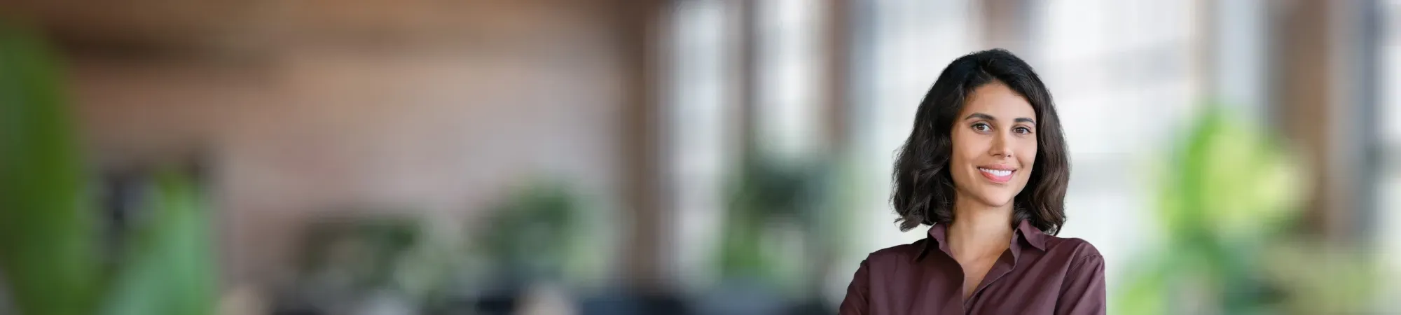 Smiling female professional wearing brown shirt