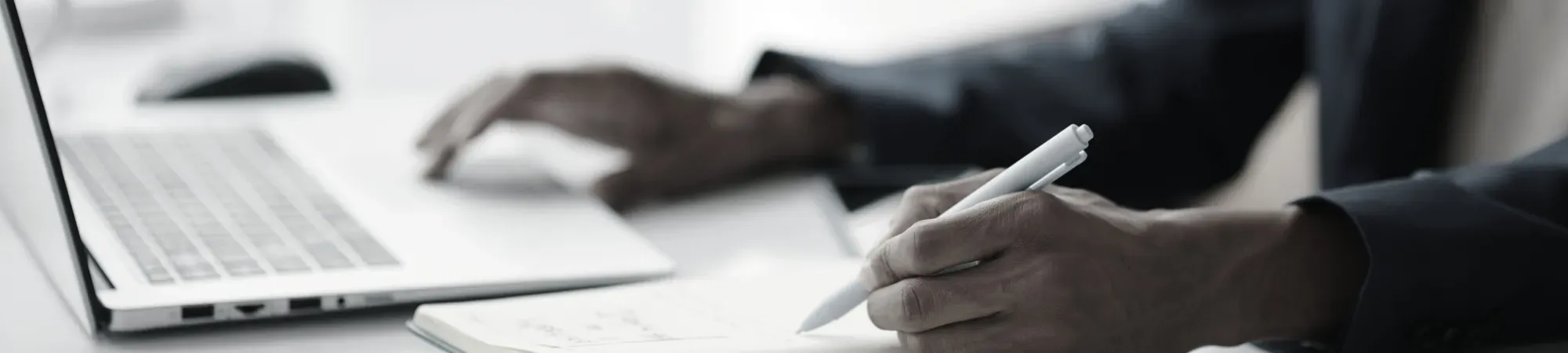 image of hands and laptop taking notes