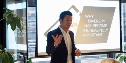 Talent Melbourne General Manager Simon Yeung presenting in front of a screen featuring the words "why diversity has become increasingly important"