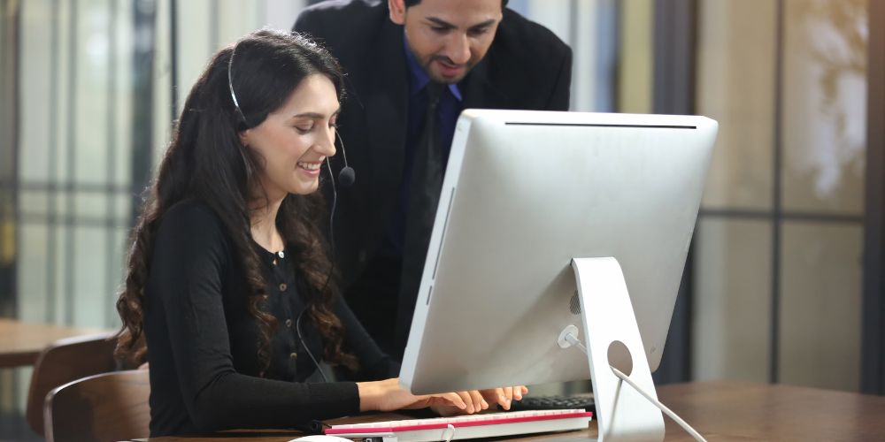 Two workers on looking at monitor