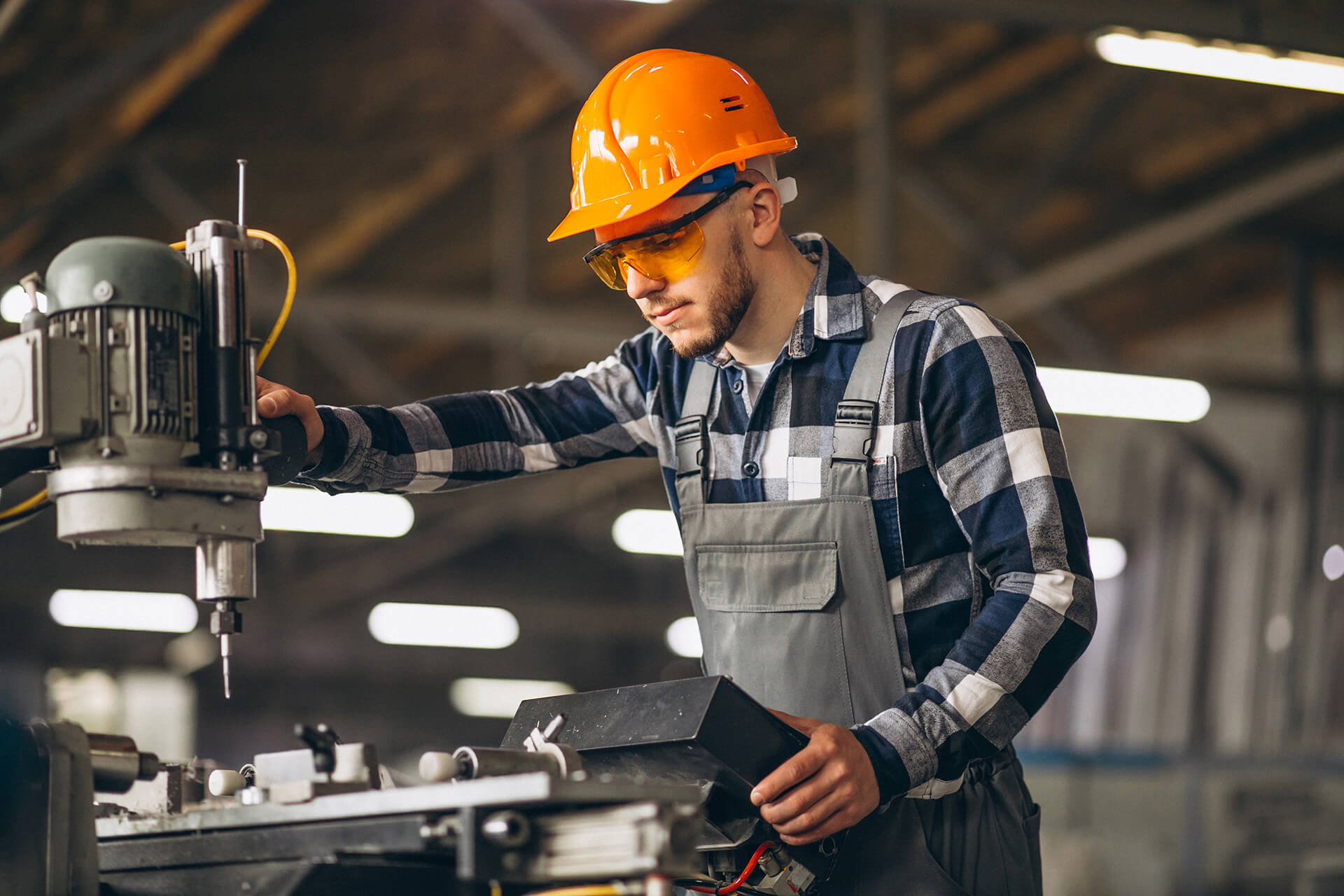 Photograph of worker operating machinery in a factory