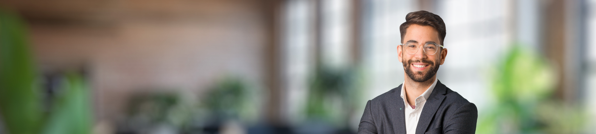 Smiling male professional wearing glasses. 