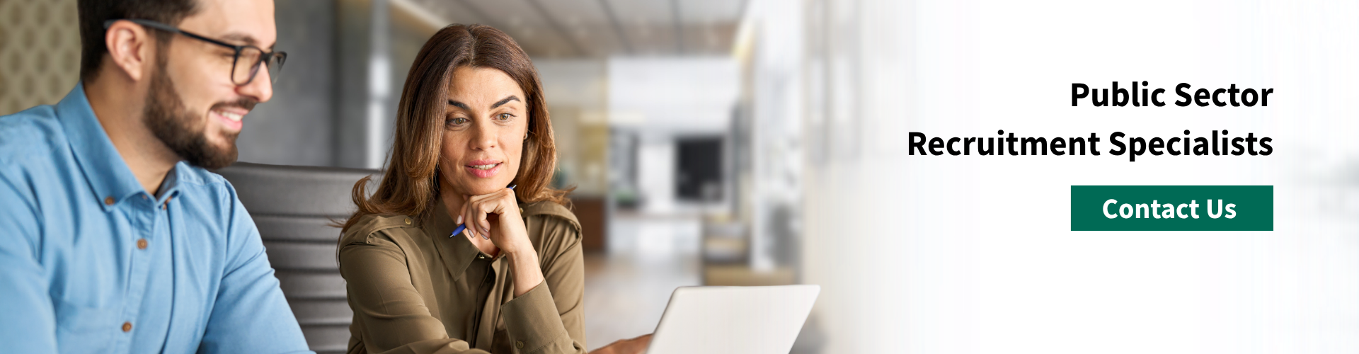 Two employees looking at computer screen.