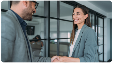 two smiling people shaking hands