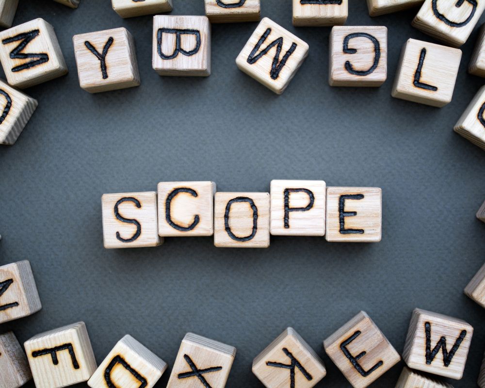 Wooden letter blocks spelling “SCOPE” surrounded by scattered blocks, symbolizing the broader reach and strategic depth of retained search compared to in-house recruiting.