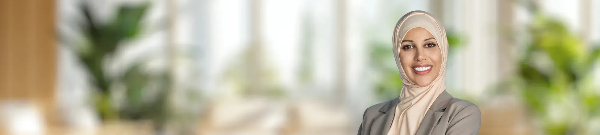 Female wearing headscarf smiling in an office