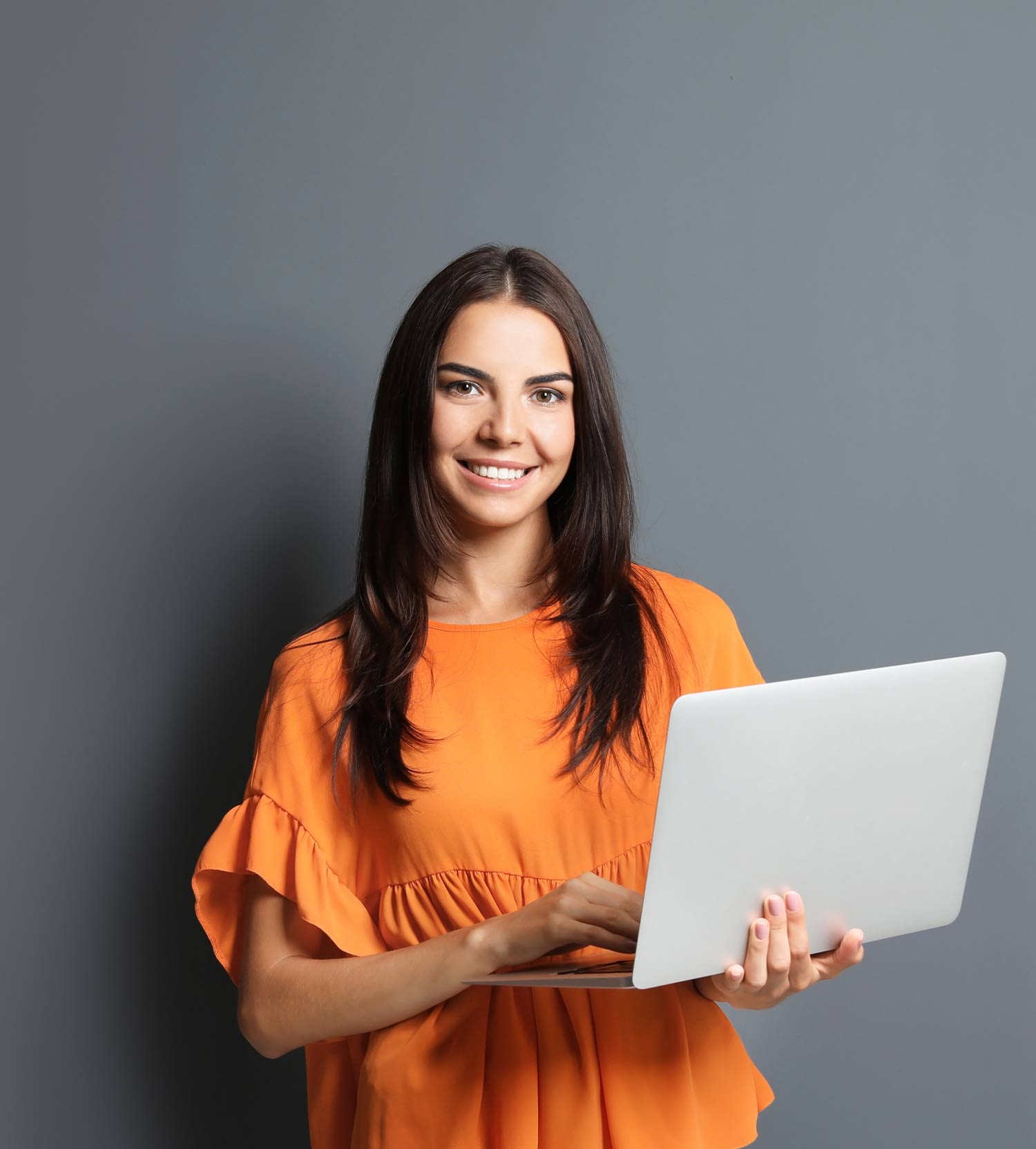 Orange Top Dark Hair Smiling Woman Working Computer