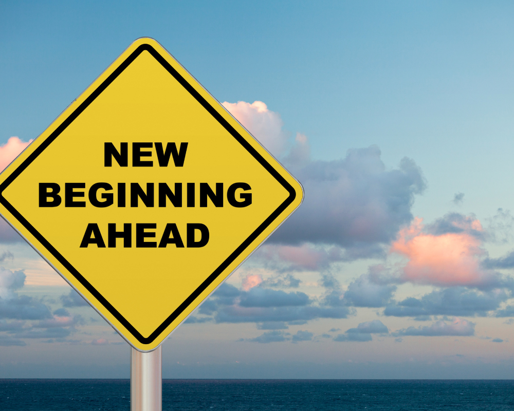 Yellow road sign saying new beginning ahead