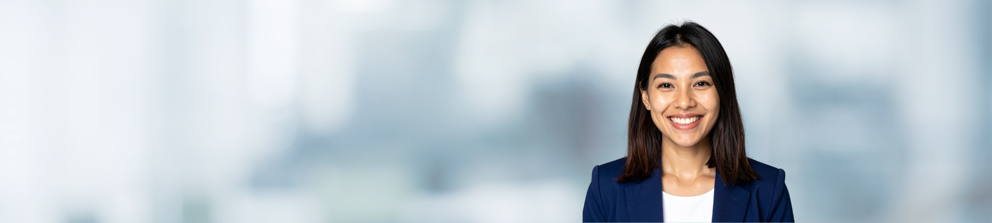Smiling female professional in blue jacket.