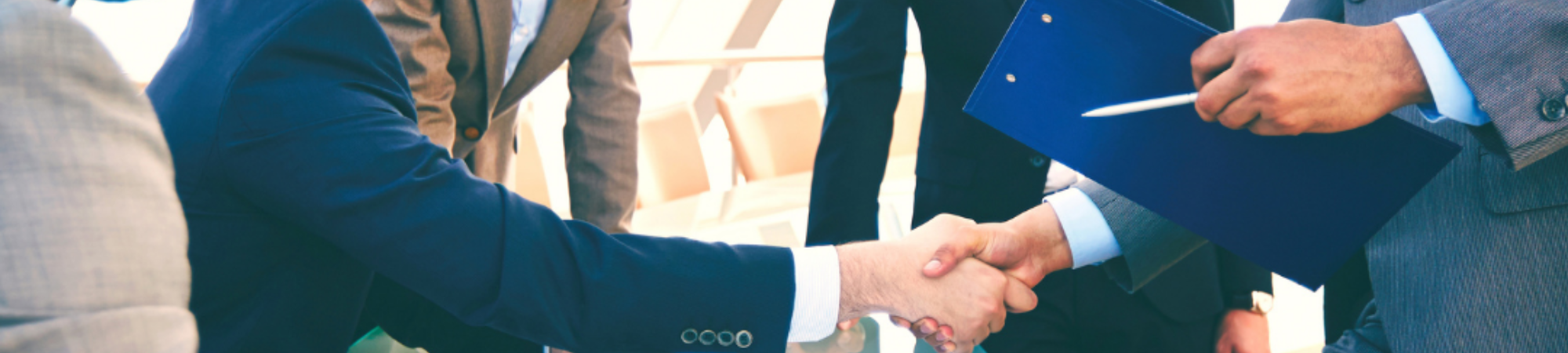 Kennedy Reid banner of two business men shaking hands