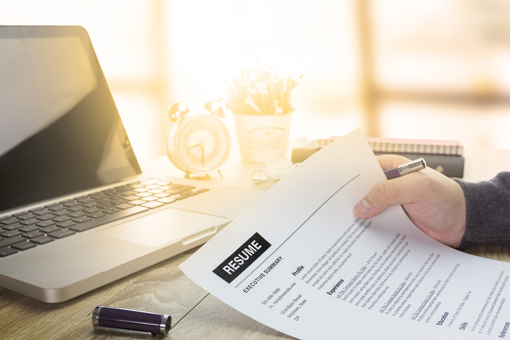 Businessman or job seeker review his resume on his desk 