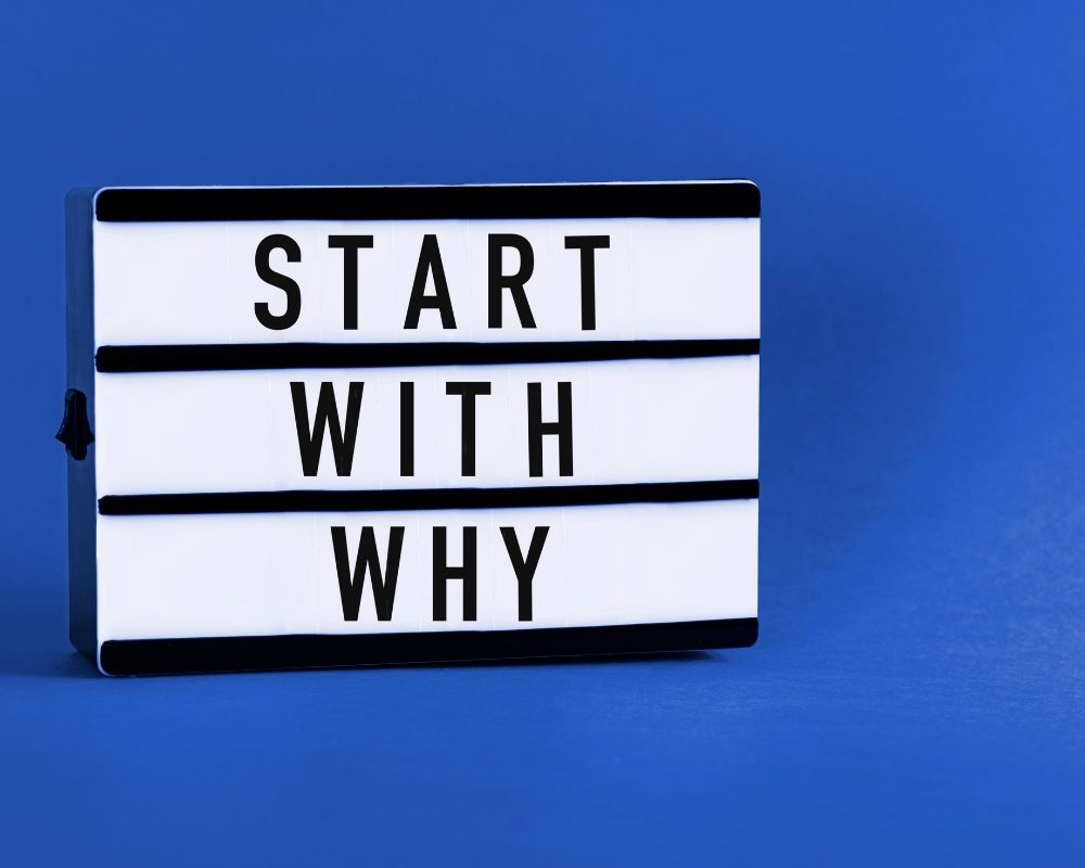 start with the why sign board on blue background