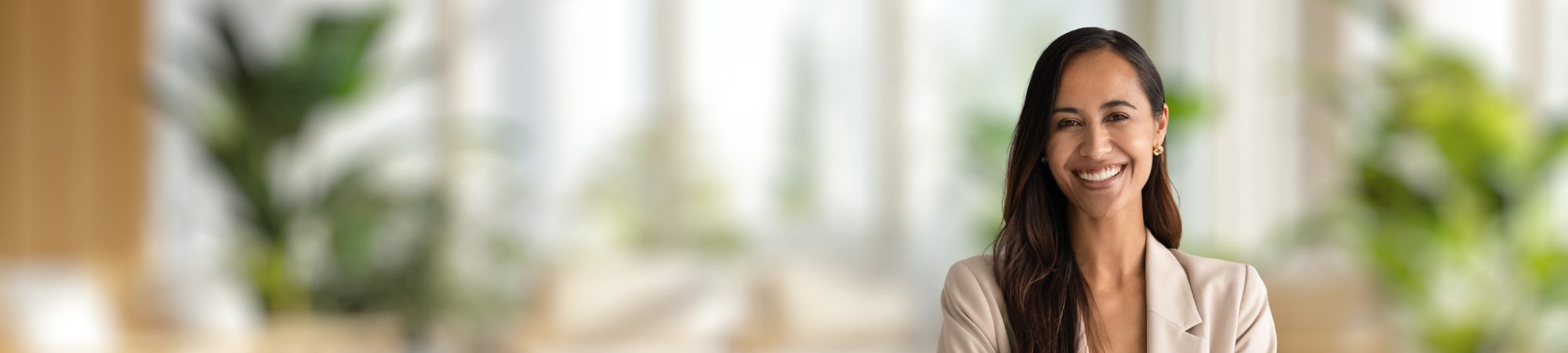 Smiling female professional wearing cream coloured jacket.