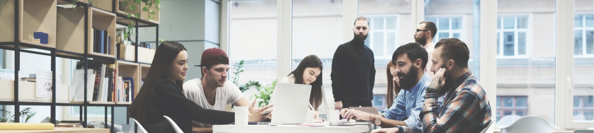 Kennedy Reid banner of employees in a team meeting