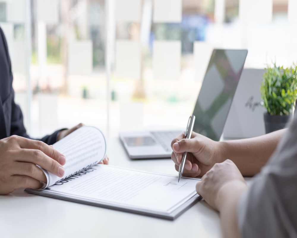 A person signing a new job contract