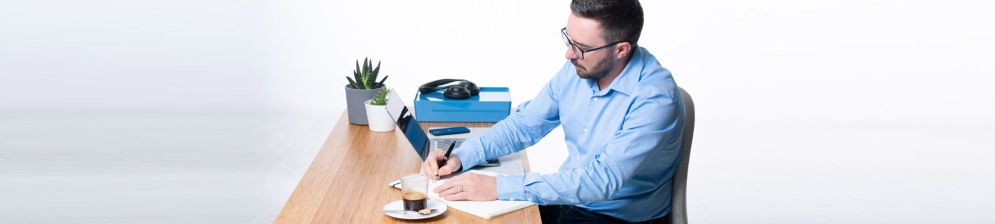 Recruiter writing notes at a desk 