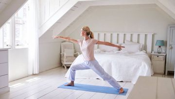 woman exercising yoga before work
