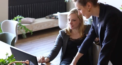 Two business women smiling