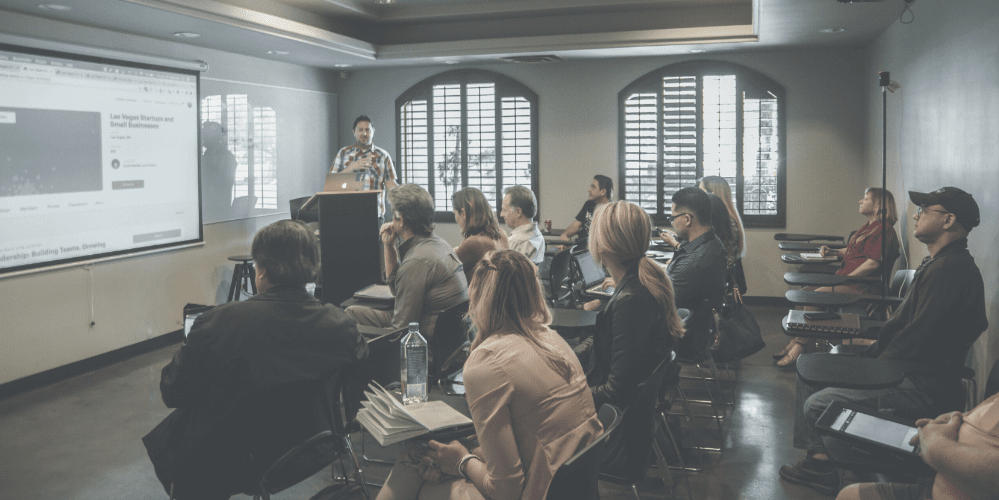 Header image of man teaching a classroom of adults