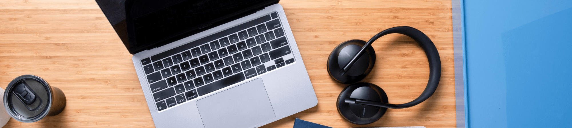 Laptop and headphones on office desk 