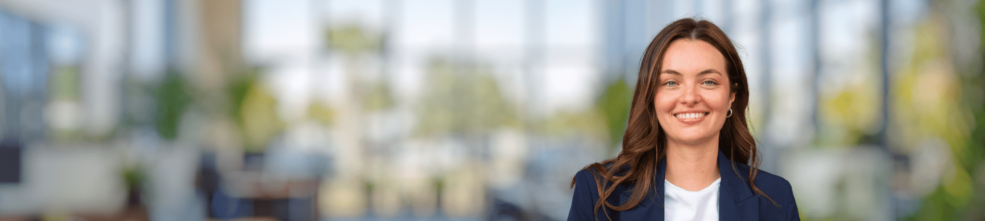 Smiling female professional wearing dark jacket.