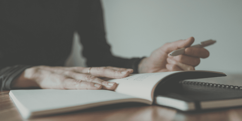 Photo of a woman writing in a notebook