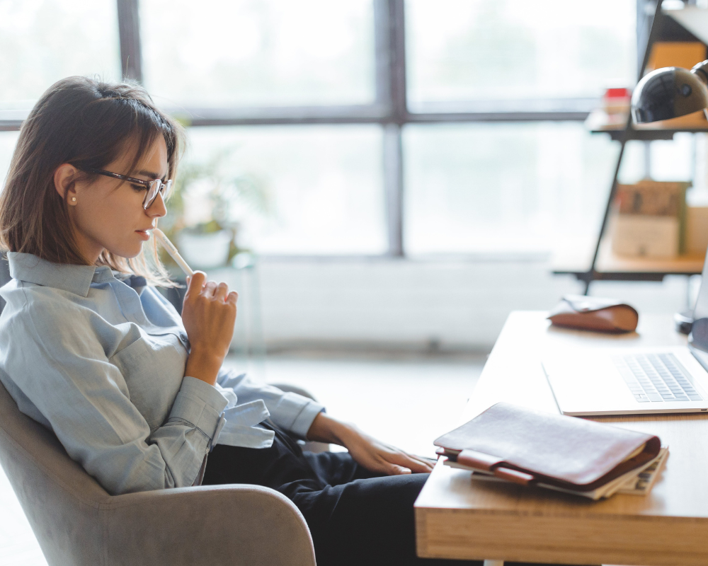 Woman sitting at the desk thinking